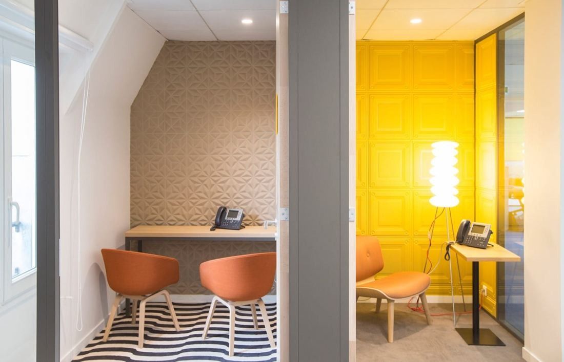 Danone: Two small phone rooms, one with a patterned wall, the other painted yellow