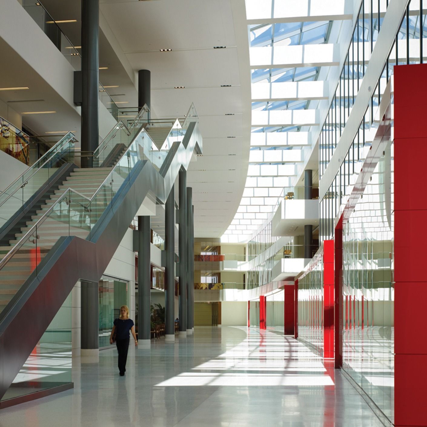 Darden Restaurants: A bright atrium with escalators, white curved ceilings and red columns