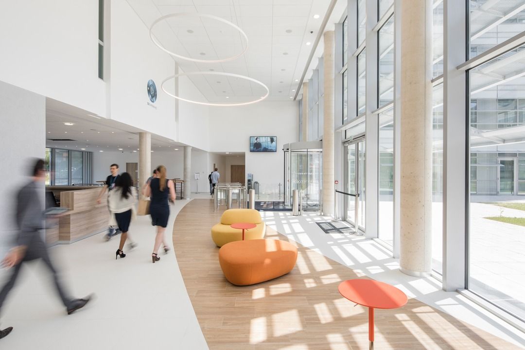 Dassault Systèmes: Entrance hall with orange seats and tall windows