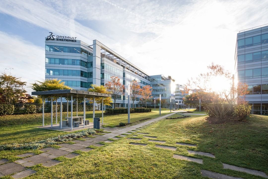 Dassault Systèmes: Path through the park toward a building with the company sign