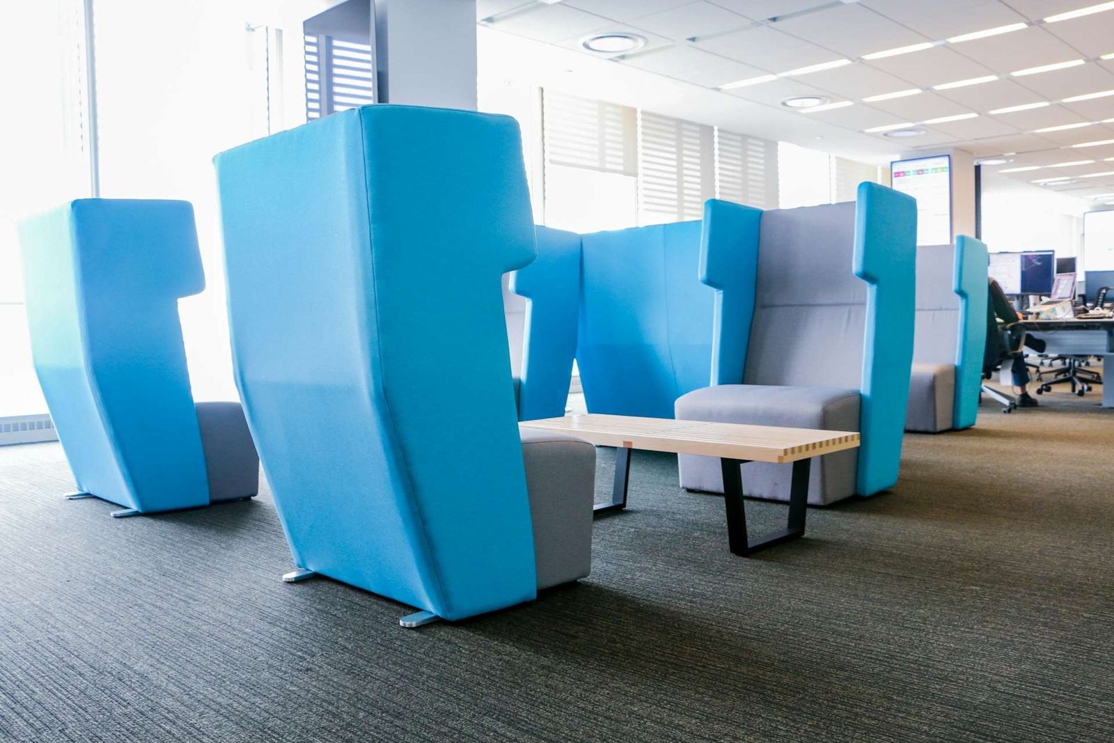 Datadog: Blue high-backed privacy seats in the open office