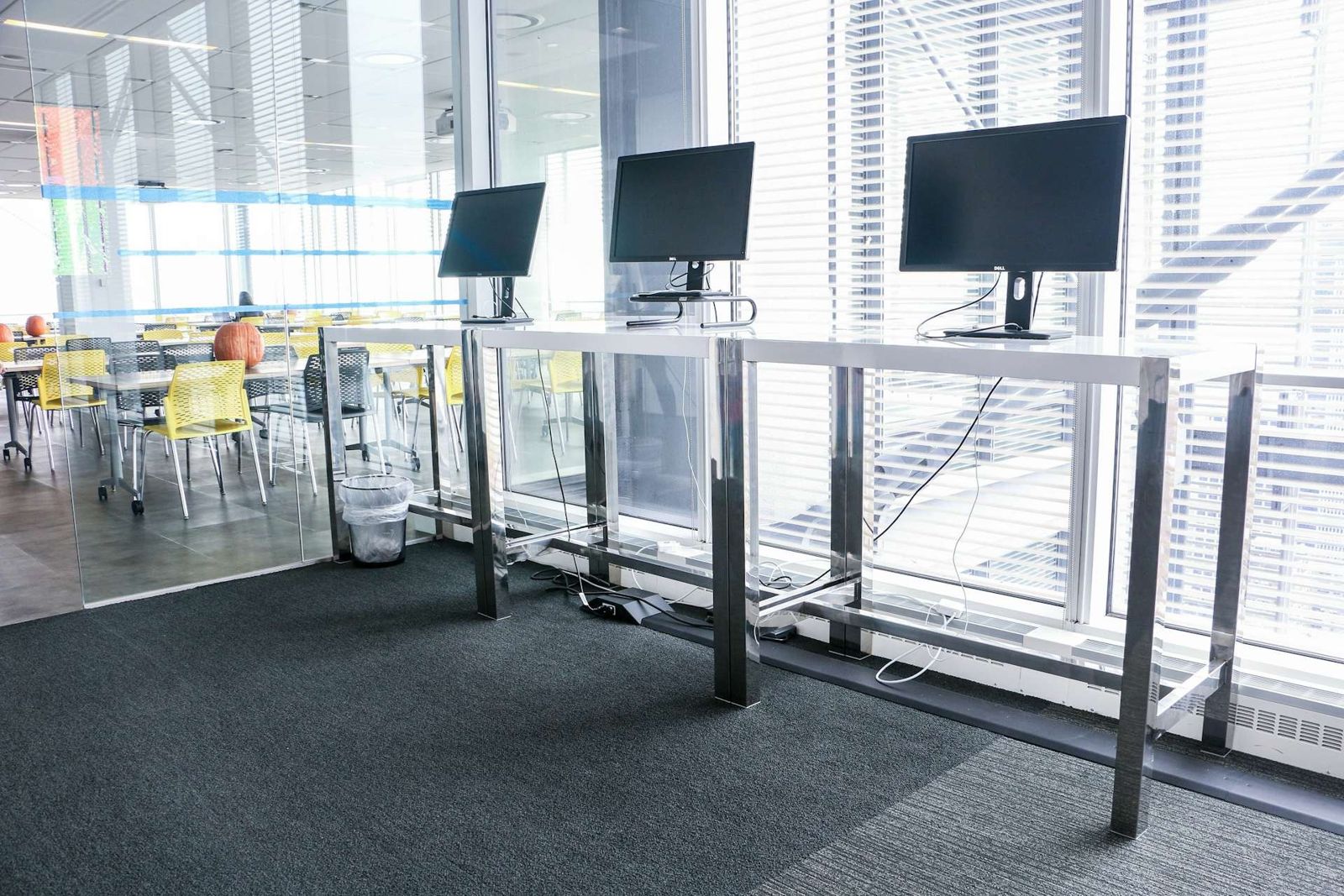 Datadog: Standing desks with monitors by the windows