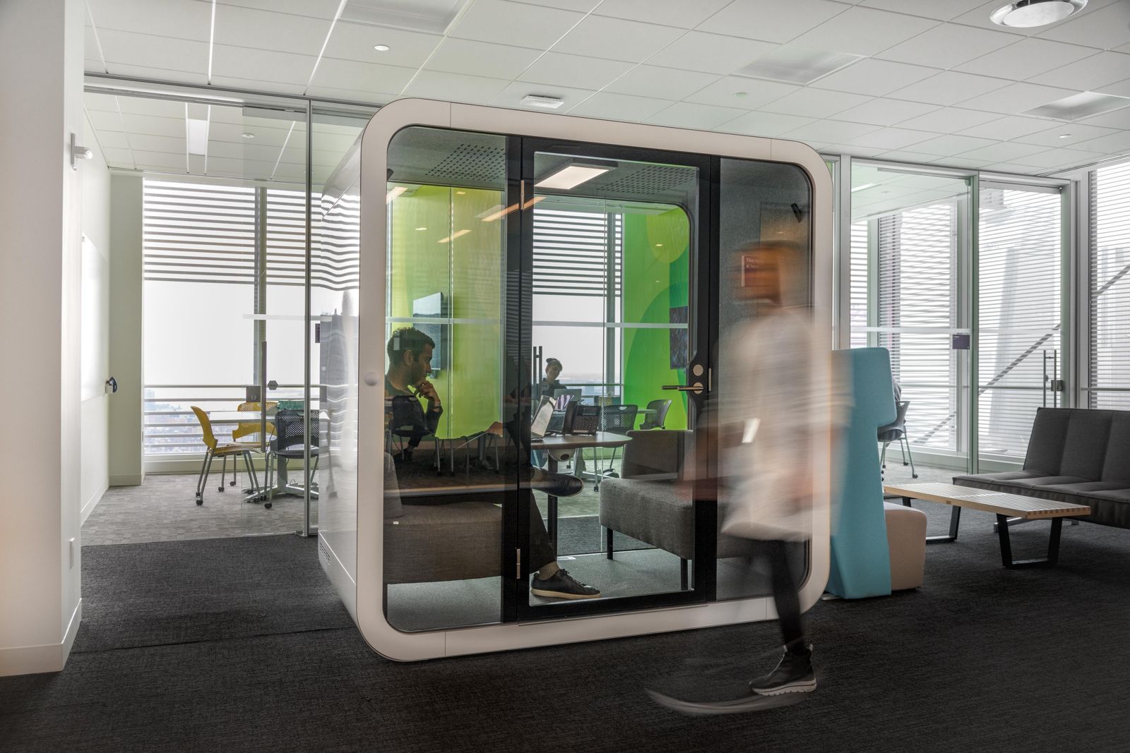 Datadog: White phone booth in an open office with city views