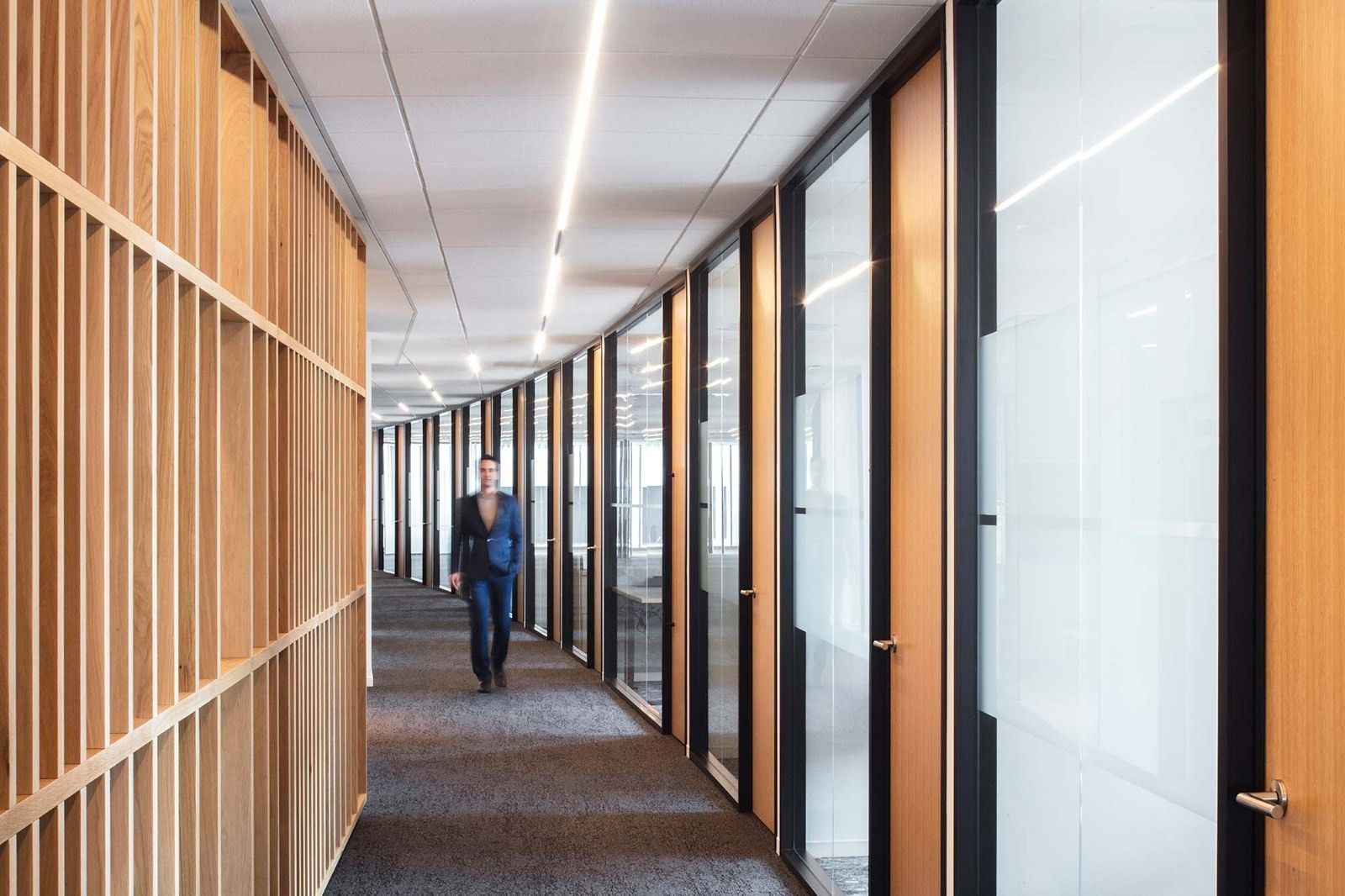 Davis Wright Tremaine: A corridor of glass-fronted offices with wood slats