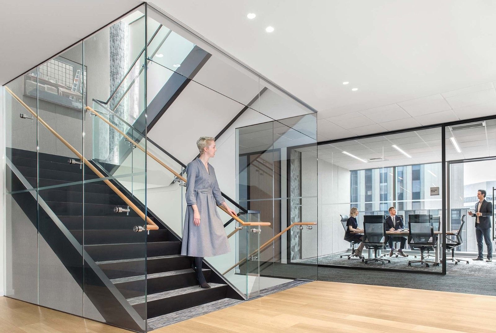Davis Wright Tremaine: A glass stair connecting floors next to a meeting room