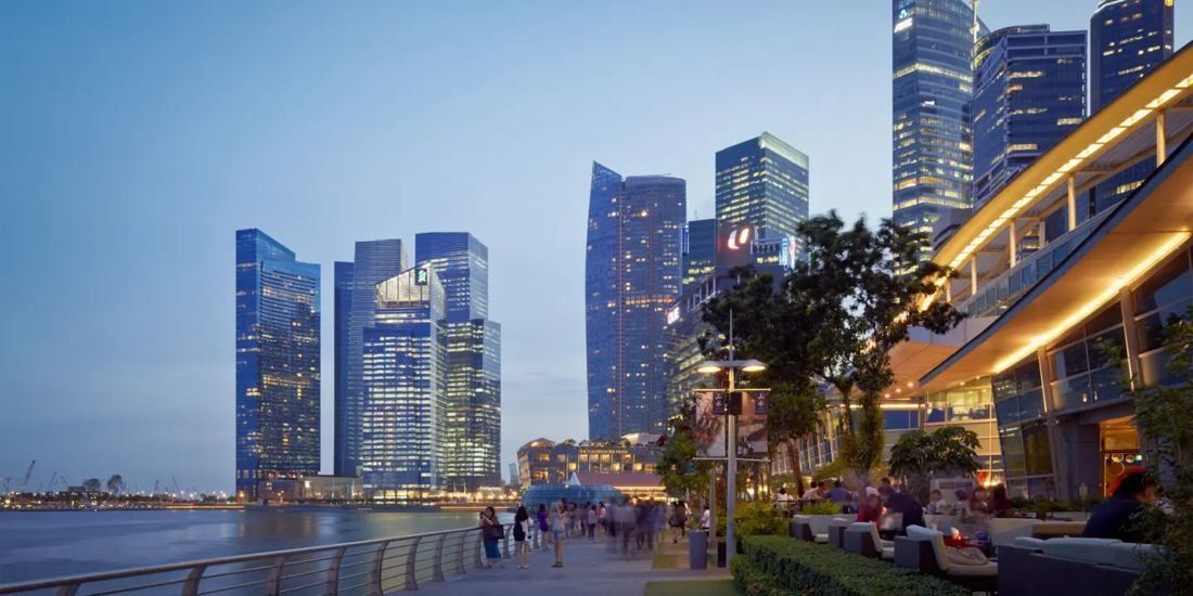 DBS Bank: Dusk view of the towers across the bay from a terrace
