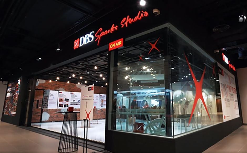 DBS Bank: Glass-fronted studio with red DBS Sparks Studio signage and an On Air light