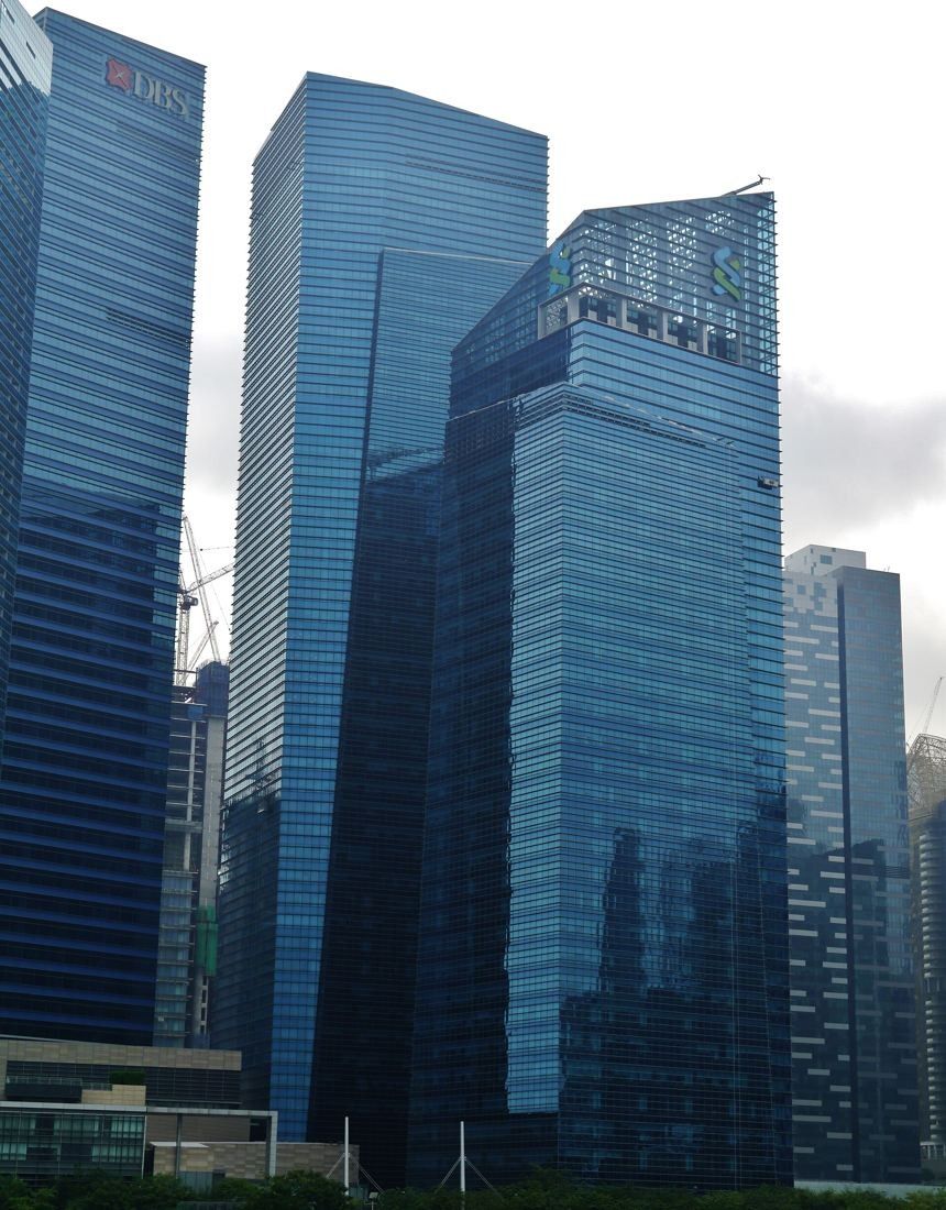 DBS Bank: Looking up at the faceted glass facades of the towers