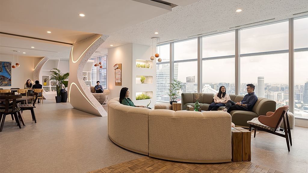 DBS Bank: Lounge with a curved beige sofa, sculpted white column and floor-to-ceiling city views