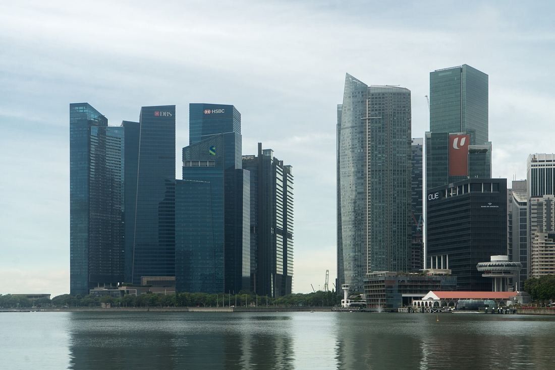 DBS Bank: Marina Bay Financial Centre and neighbouring towers reflected in calm water