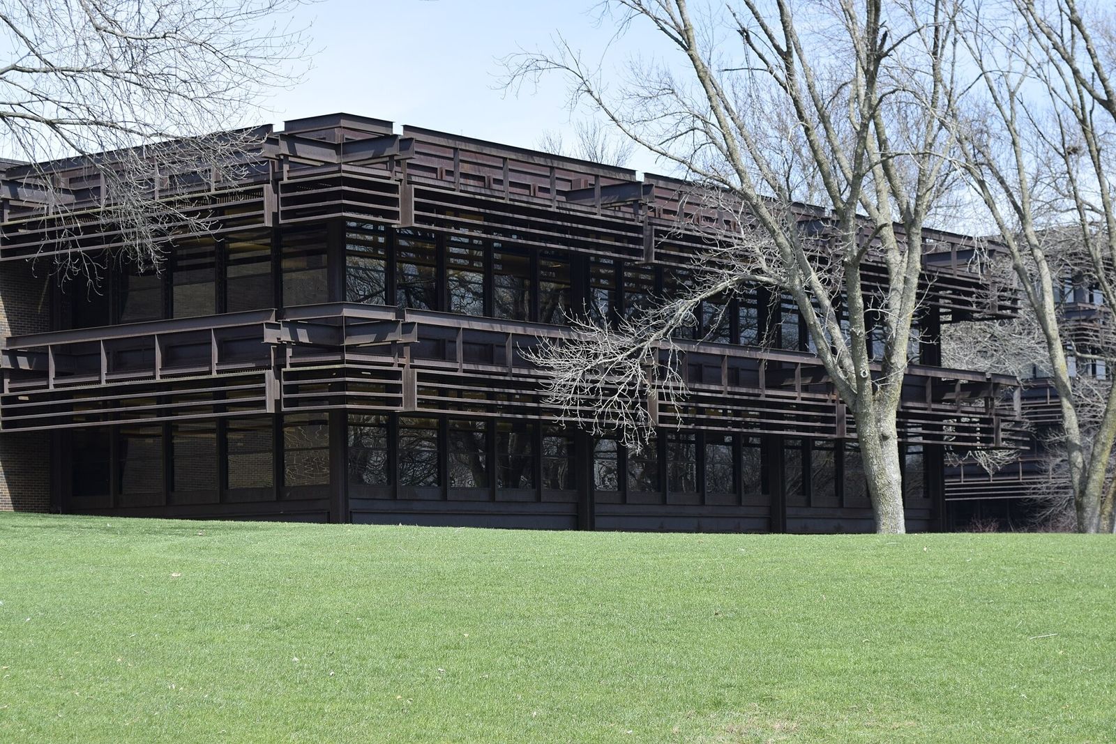 John Deere: Low building with layered steel sunshades behind bare trees