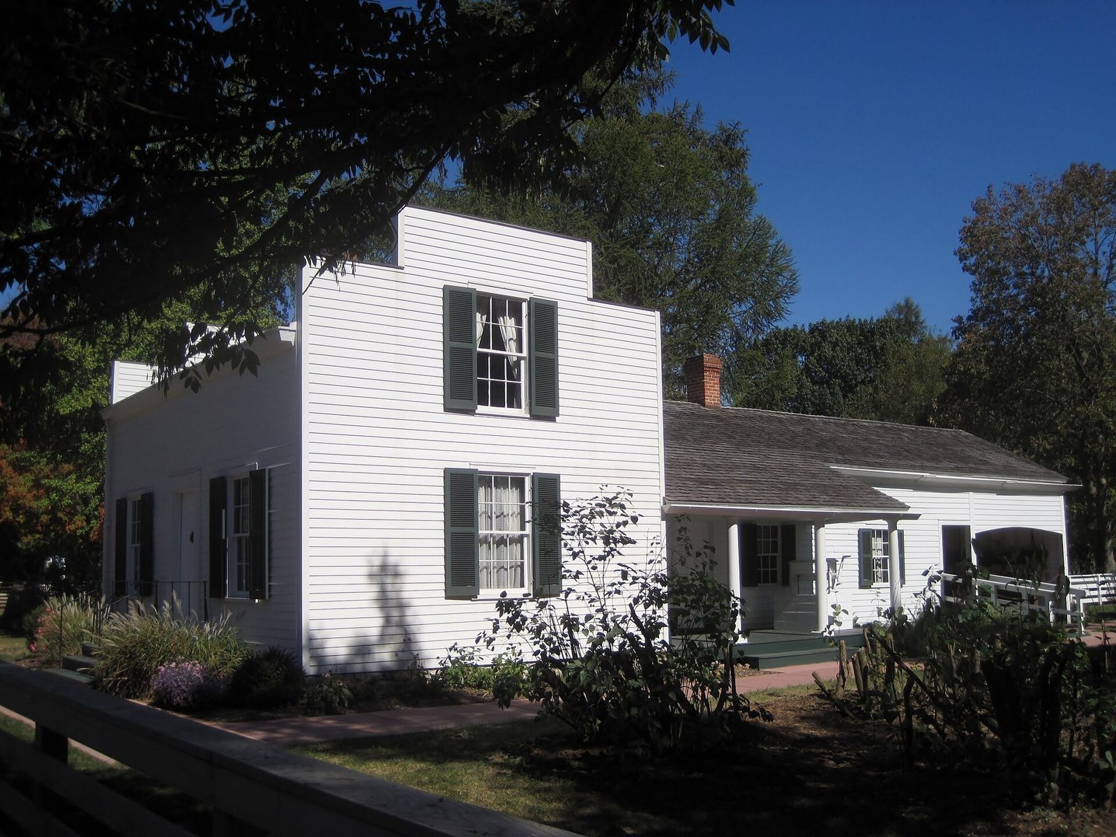 White wooden house and a small shop building