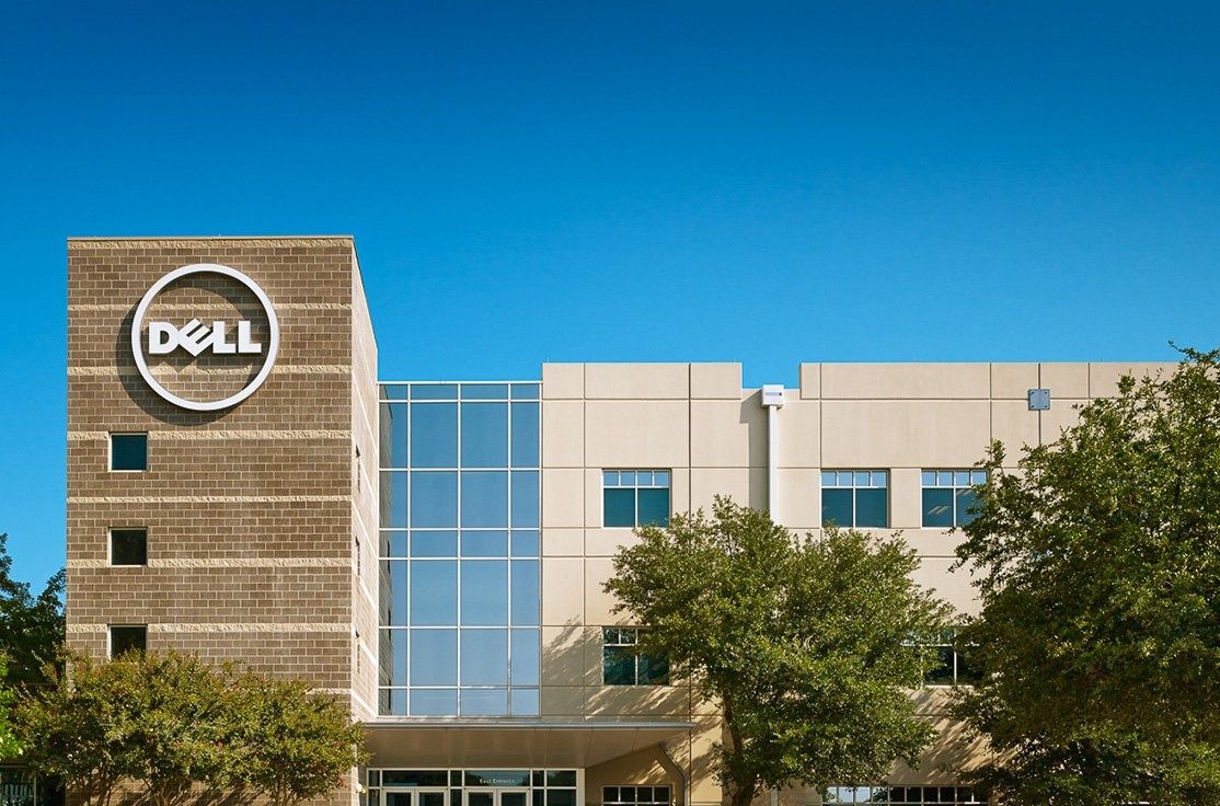 Dell Technologies: A Dell logo on a stone tower beside glass