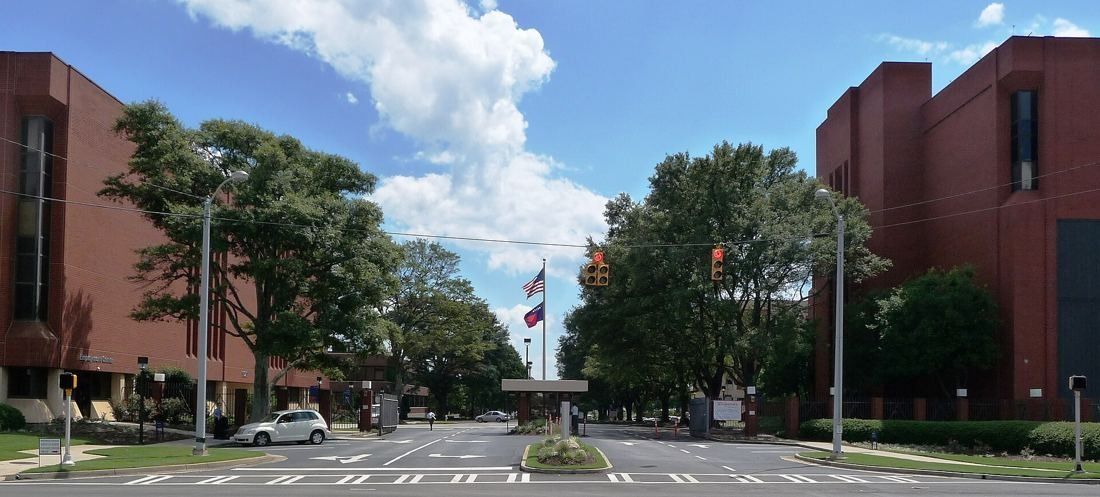 Delta Air Lines: Tree-lined entrance drive leading to red-brick office buildings under a blue sky
