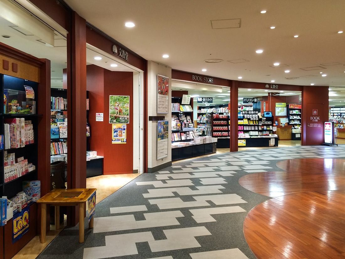 Dentsu: Bookstore entrance off a corridor with a patterned wooden floor
