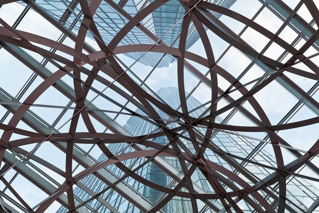 Deutsche Bank: Close view of crossing steel bands of the sphere against a glass roof