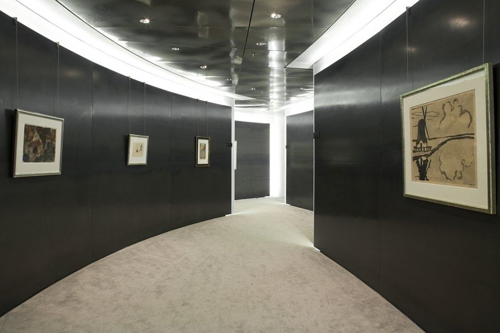 Deutsche Bank: Curved dark corridor with framed artworks on the walls