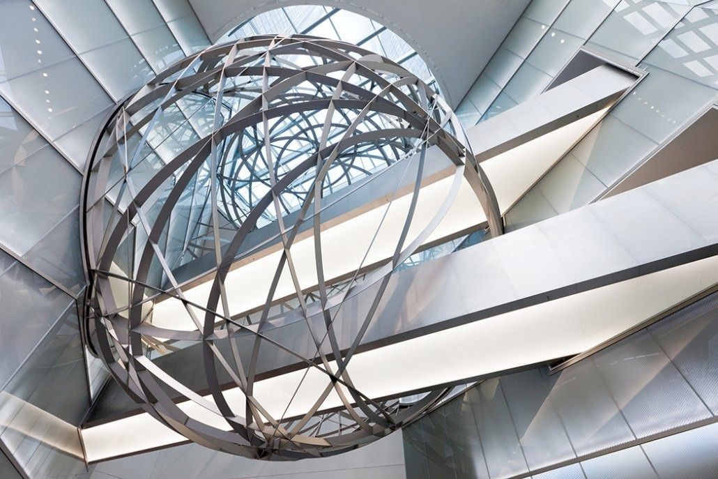 Deutsche Bank: Large stainless-steel sphere sculpture suspended in a bright atrium with glass walls