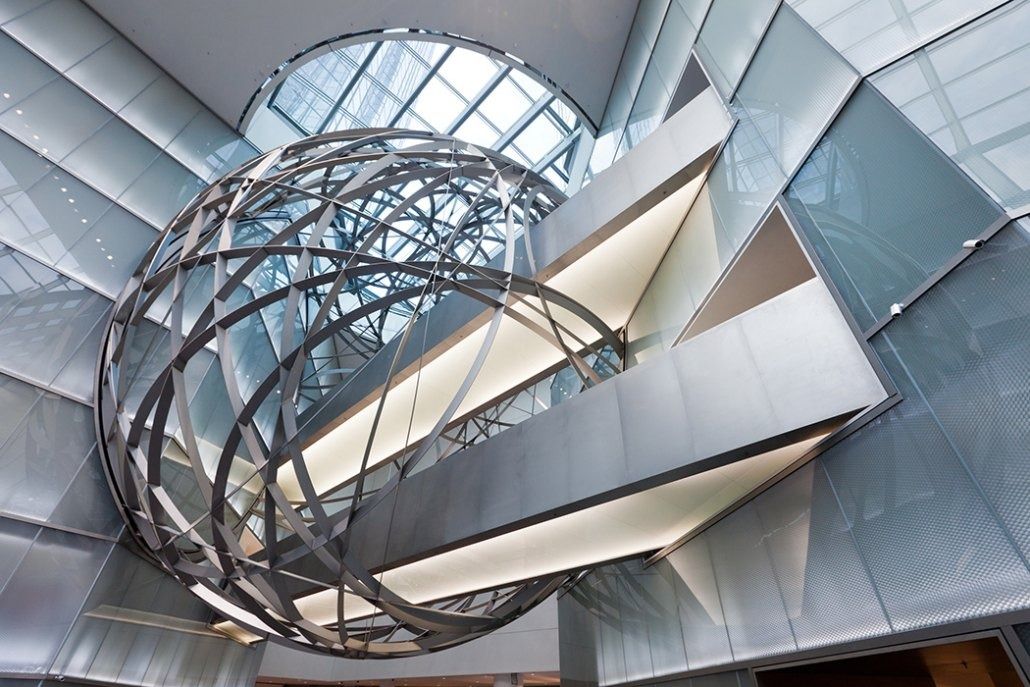 Deutsche Bank: Metal sphere sculpture seen from above, with curved bridges and glass panels around it
