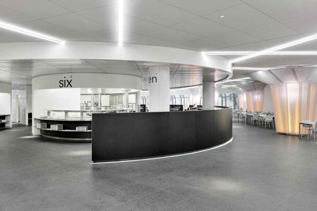 Deutsche Bank: Open dining area with curved black counter and white ceiling light lines