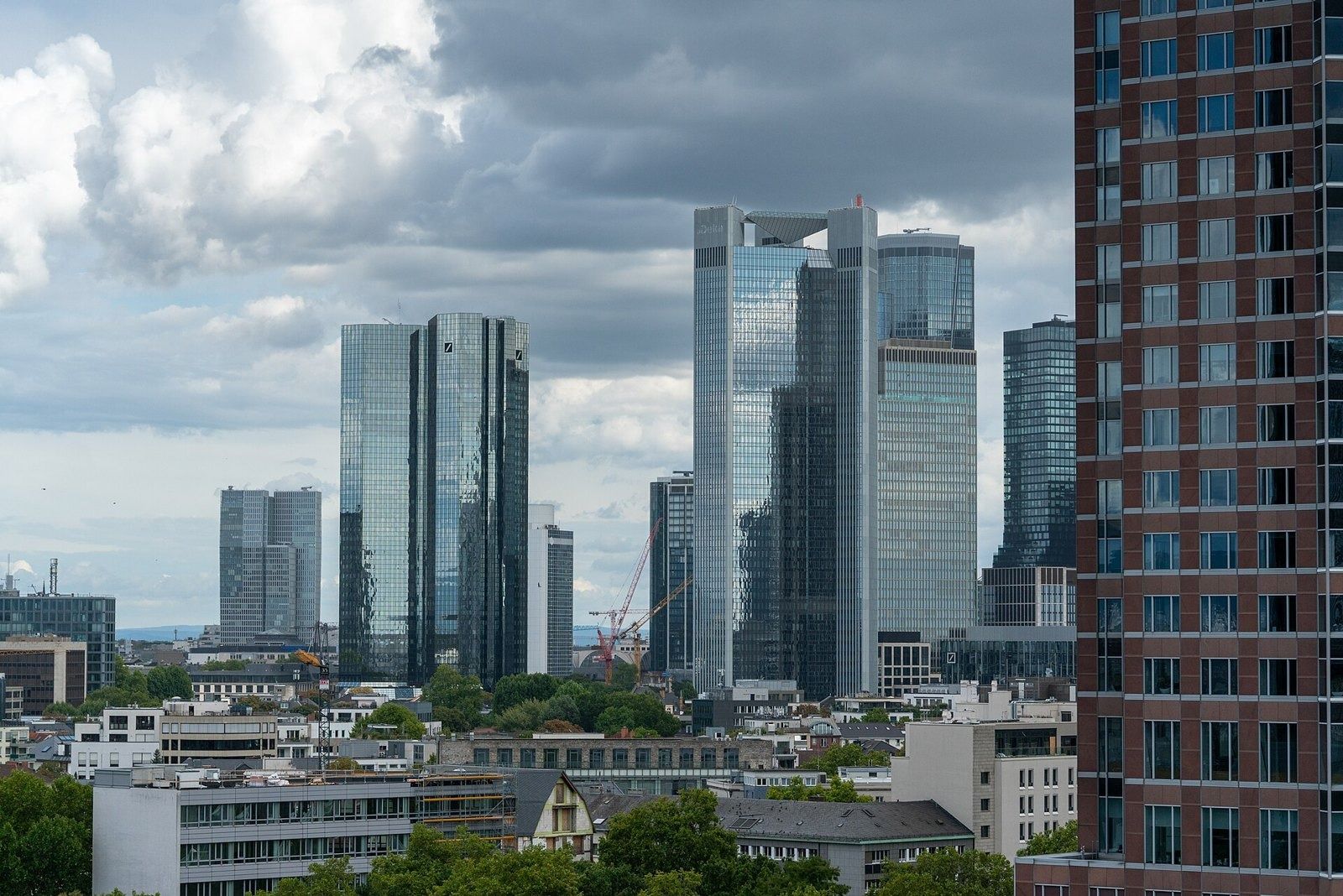 Deutsche Bank: Twin glass towers in the Frankfurt skyline under a cloudy sky