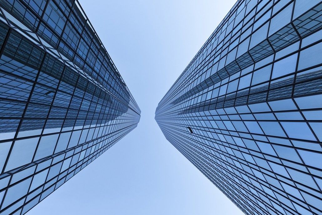 Deutsche Bank: Two glass facades converging towards the sky, seen straight up