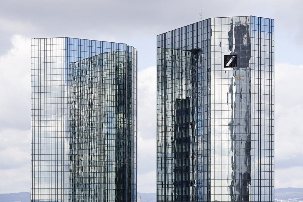 Deutsche Bank: Two mirrored glass towers against a pale sky