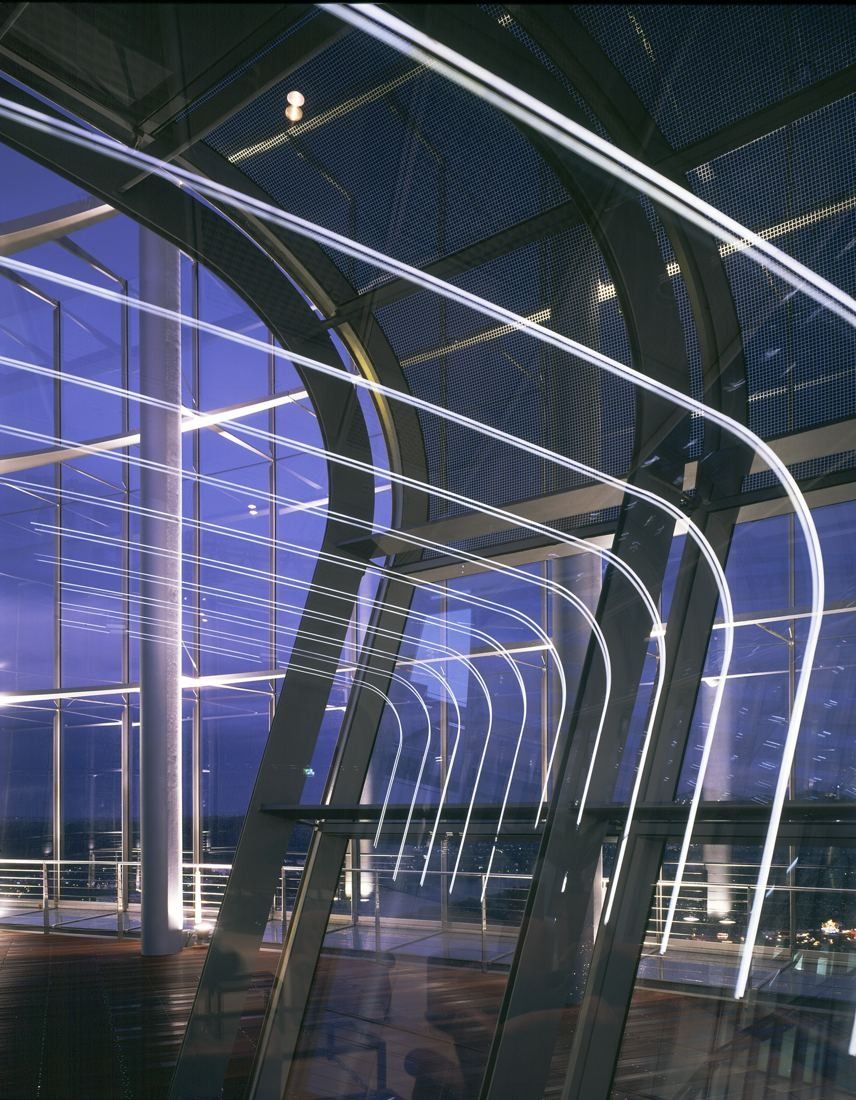 DHL Group: Curved steel-and-glass arches lit at night