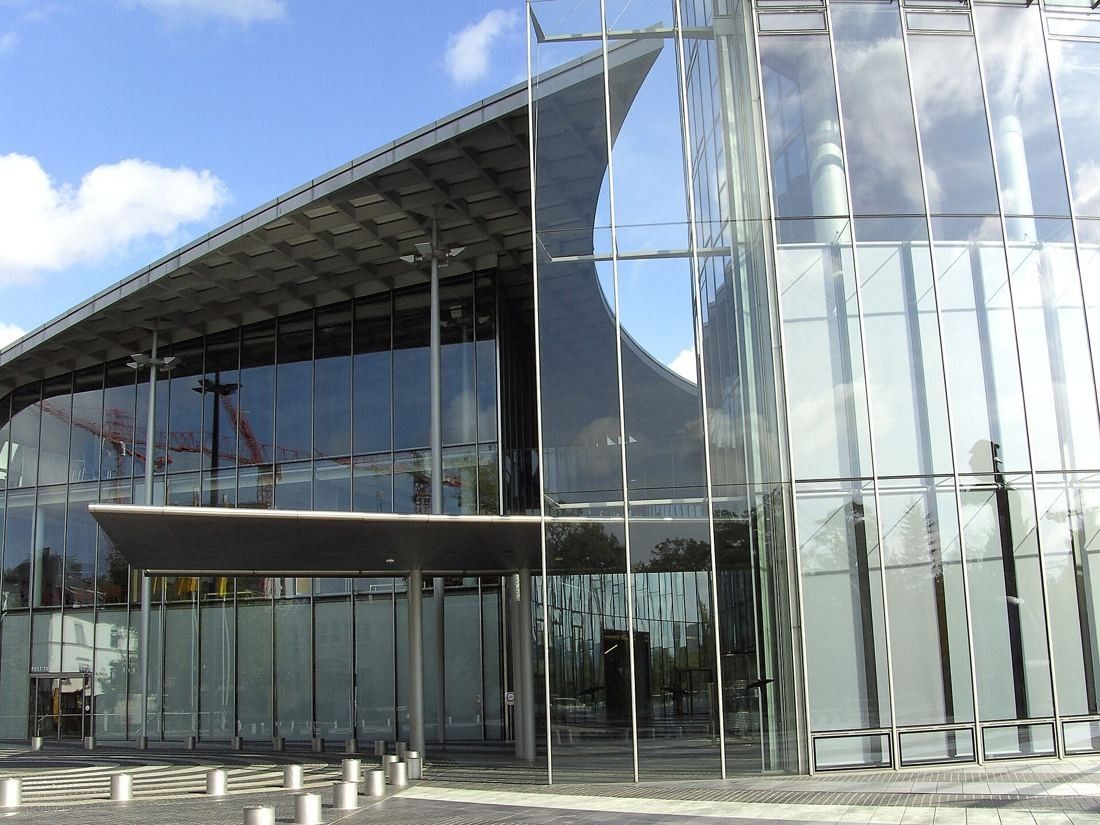 DHL Group: Glass entrance pavilion under a large flat canopy