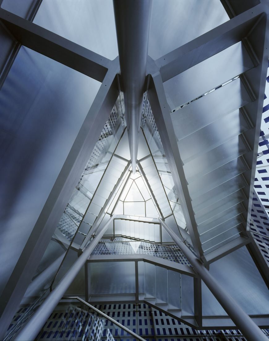 DHL Group: Looking up through crossed steel members to a glass roof