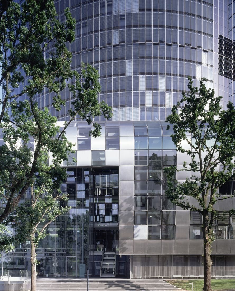 DHL Group: Lower floors of the tower behind young trees