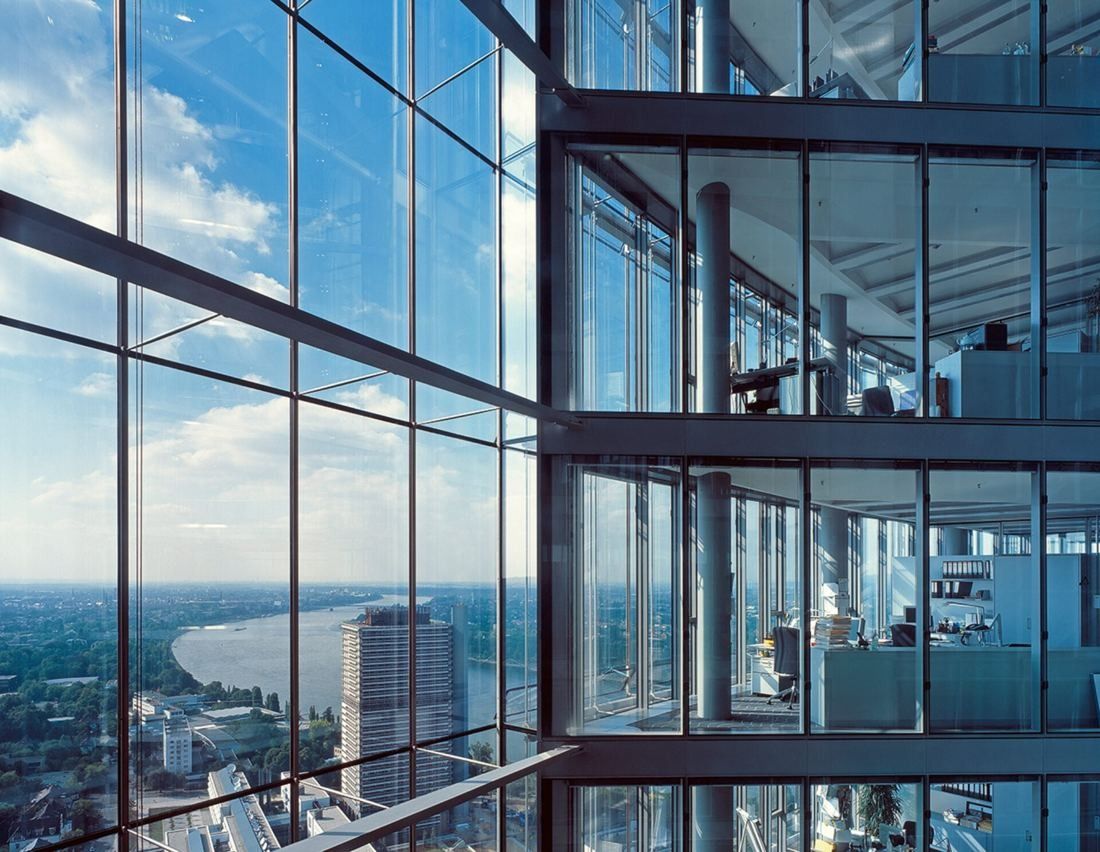 DHL Group: Office floor behind a double glass façade, with the Rhine far below