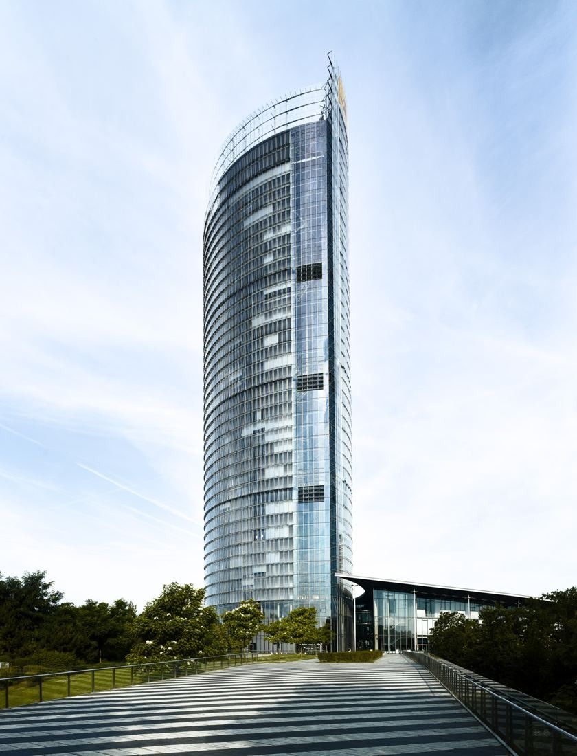 DHL Group: Slender glass tower beyond a wide flight of outdoor steps