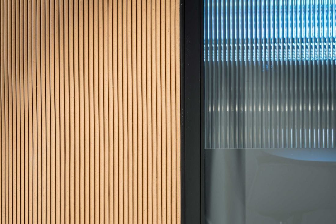 Diageo: Close-up of vertical timber slats beside reeded glass