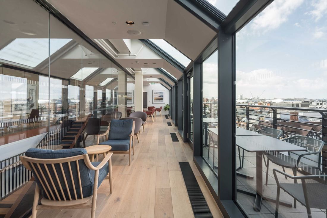 Diageo: Glazed top-floor room with armchairs opening onto a terrace with views over London rooftops