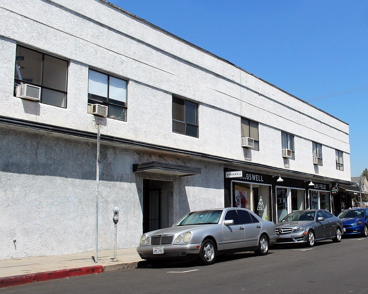Two-storey white commercial building on Kingswell Avenue