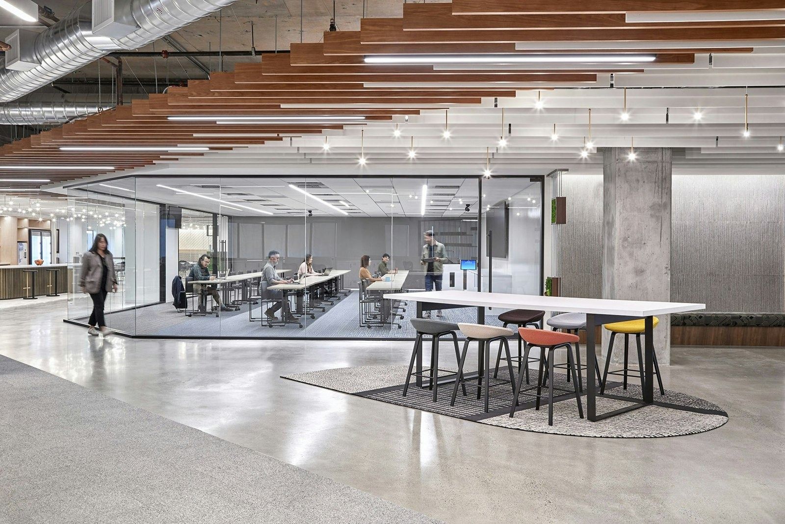 DoorDash: Open floor with high tables under timber ceiling slats