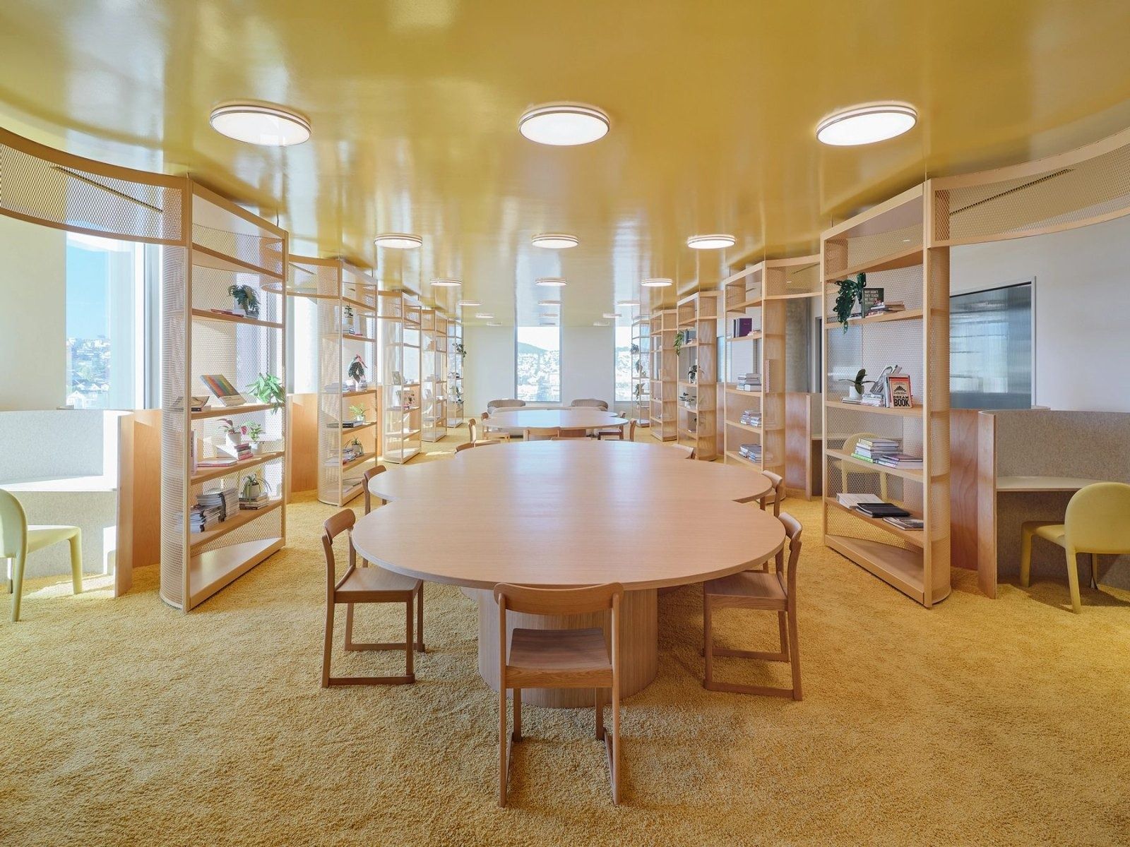 Dropbox: A library with a round table and tall shelves under a gold ceiling