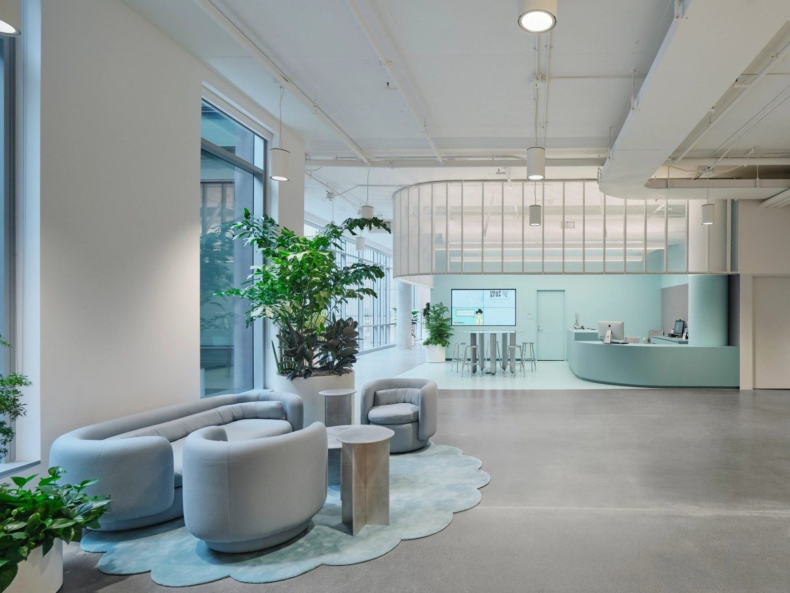 Dropbox: A lounge with grey armchairs on a scalloped rug
