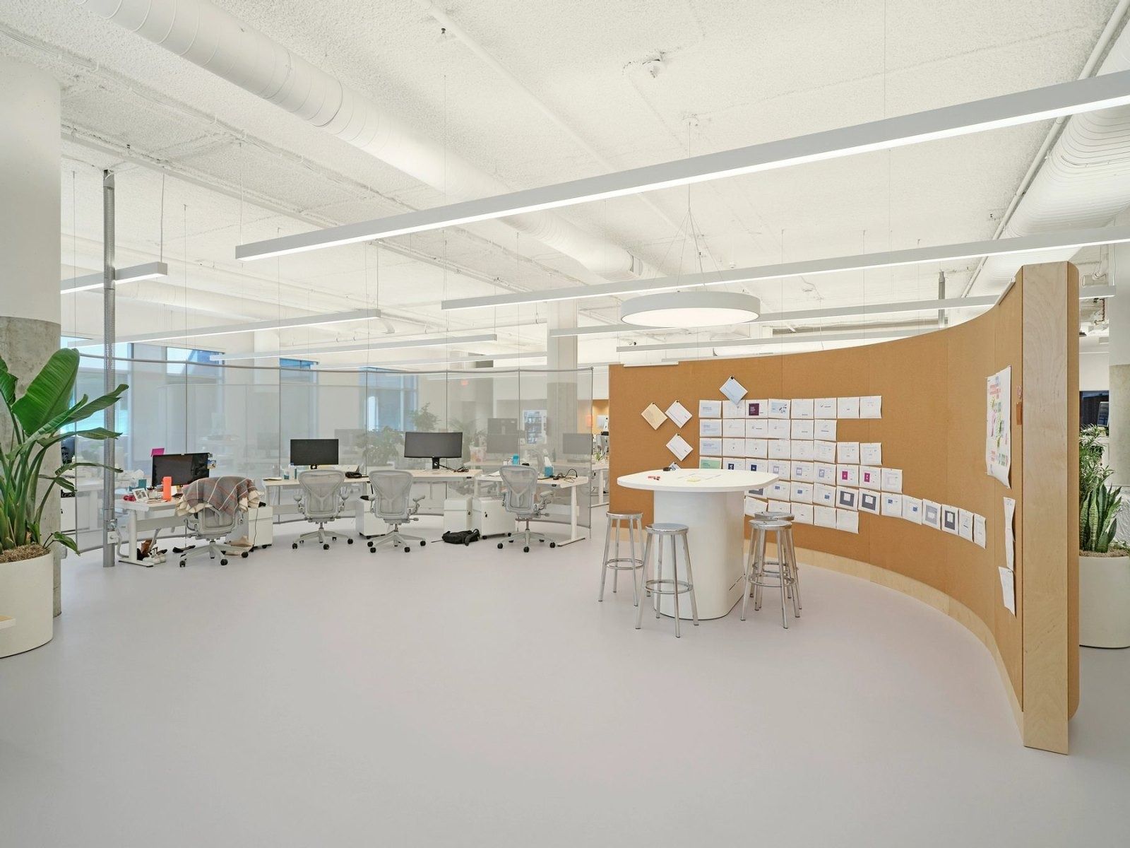 Dropbox: Desks beside a curved cork wall with notes