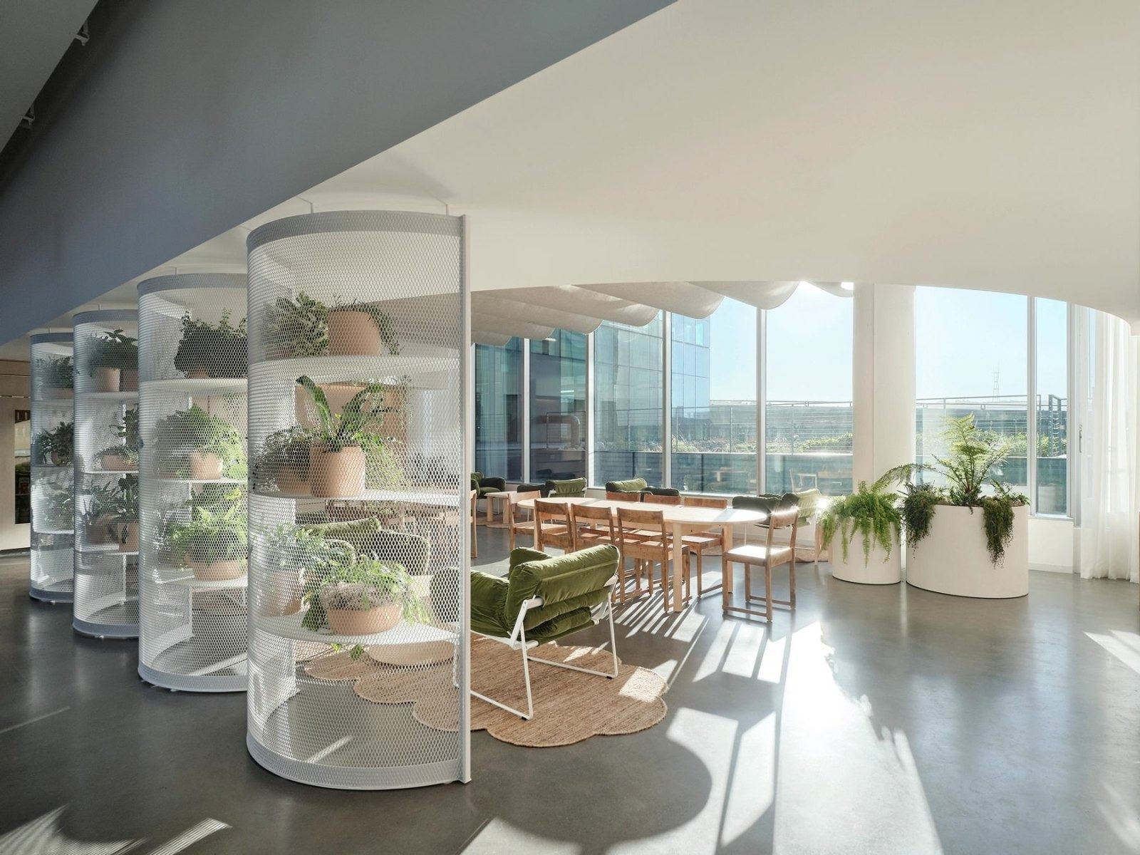 Dropbox: Glass plant cases in front of a dining area with city views