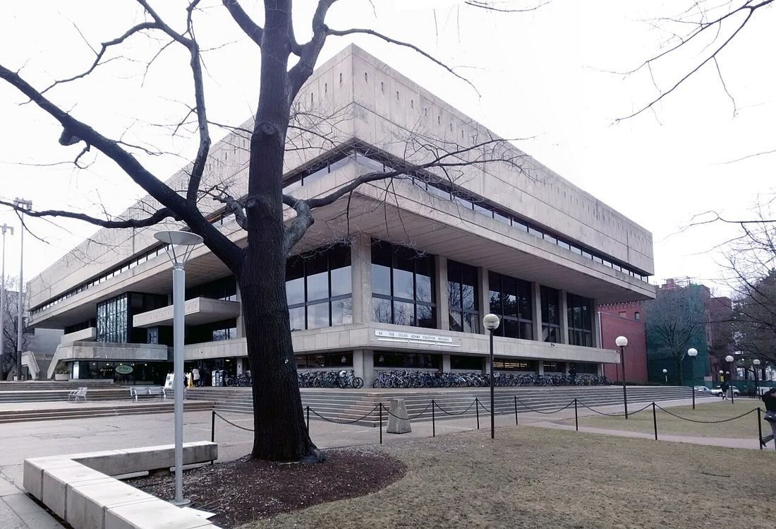 Concrete modernist student center building behind bare trees