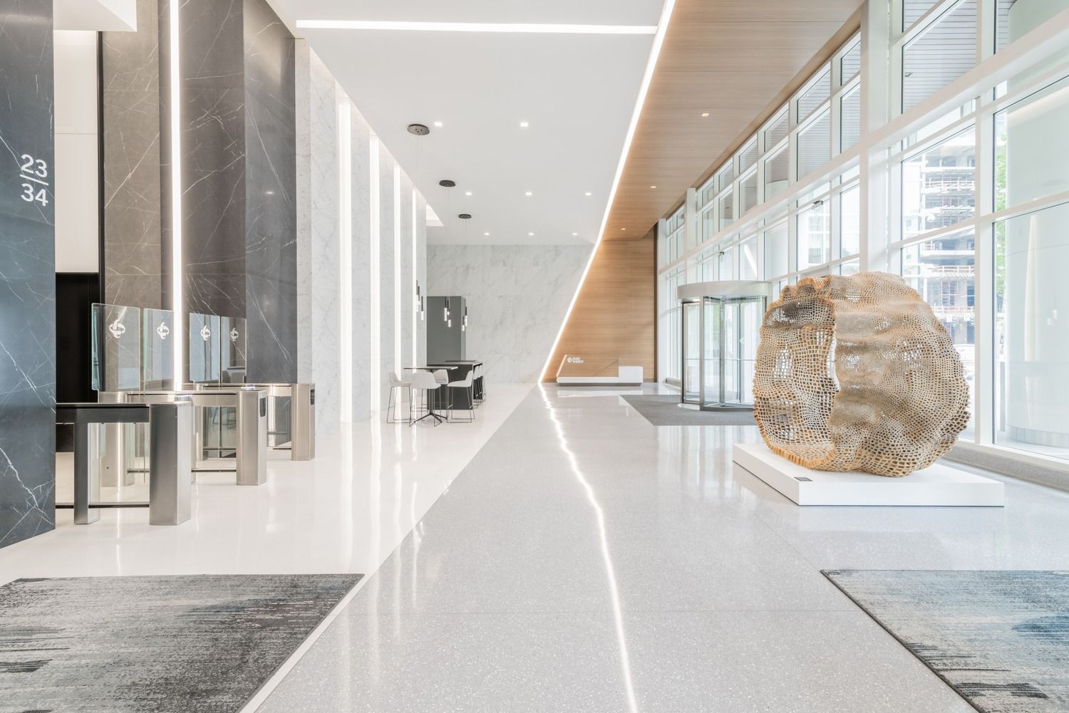 Duke Energy: A long white lobby with a large boulder sculpture
