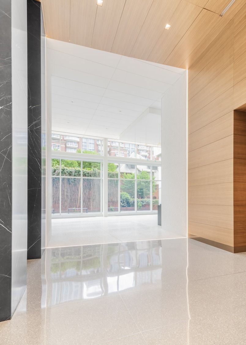 Duke Energy: A wood-lined passage opening onto a bright glass wall