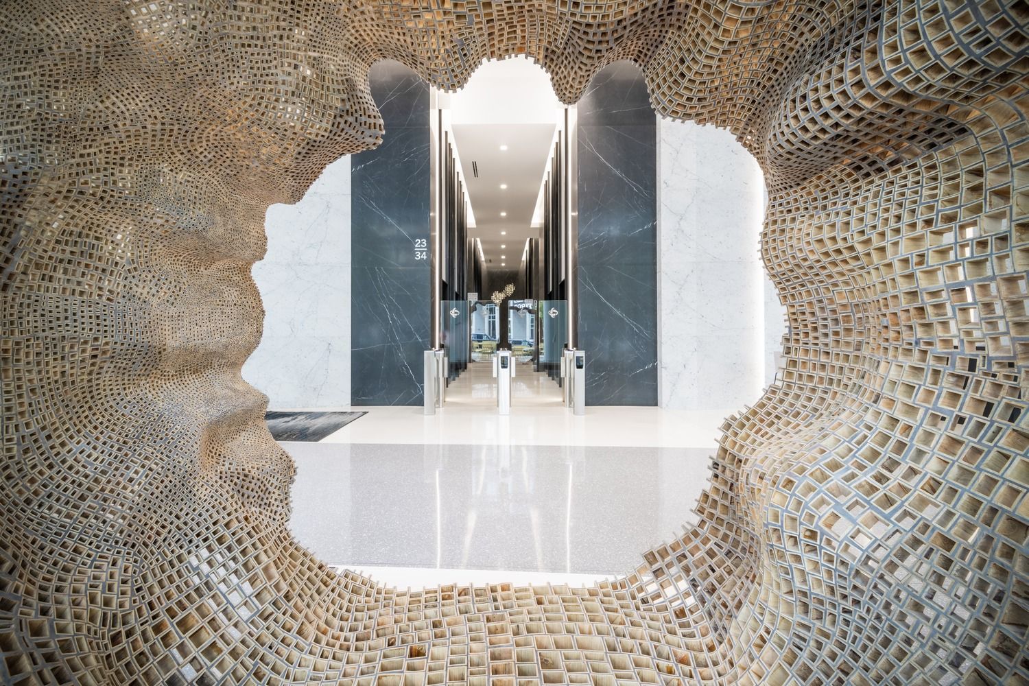 Duke Energy: Looking through an opening in a woven sculpture toward elevators
