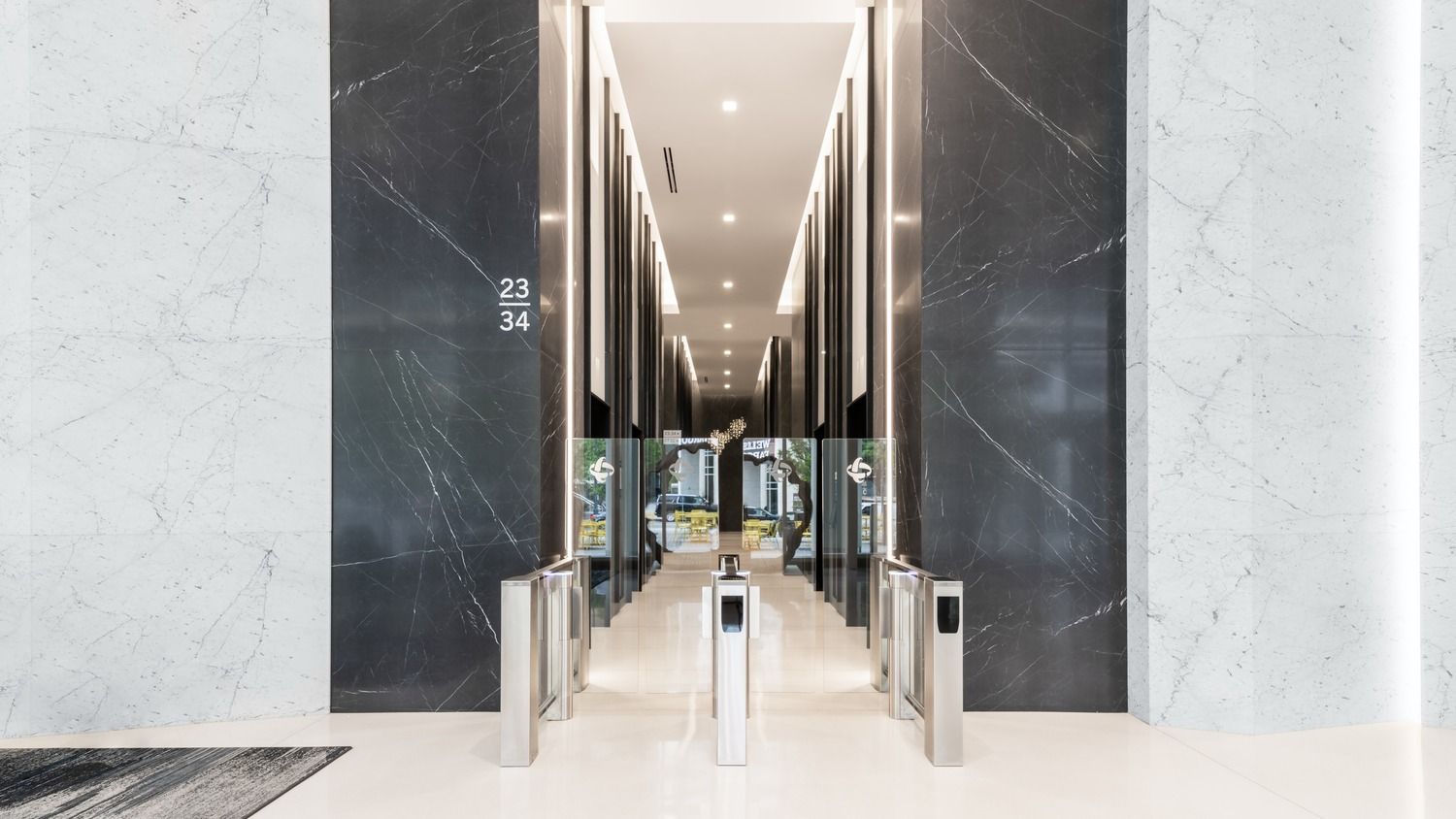 Duke Energy: Turnstiles between marble walls leading to elevators