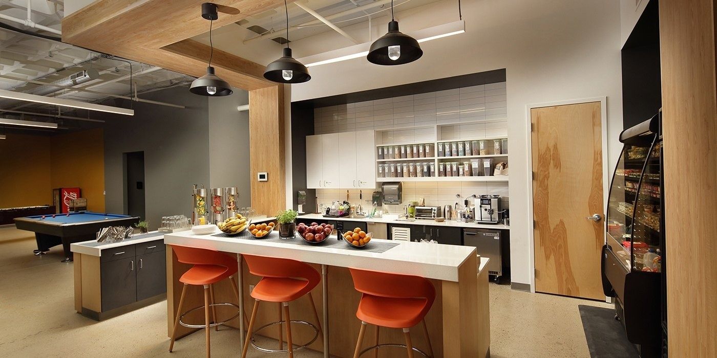 Duolingo: Kitchen island with orange stools, food displays and a pool table behind