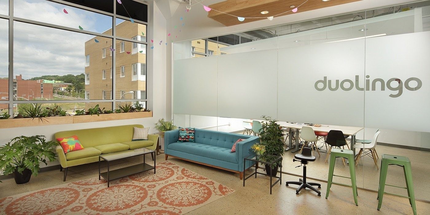 Duolingo: Reception area with sofas, plants and frosted glass bearing the duolingo name