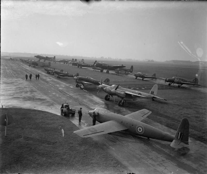 Black-and-white photo of training aircraft lined up on an airfield