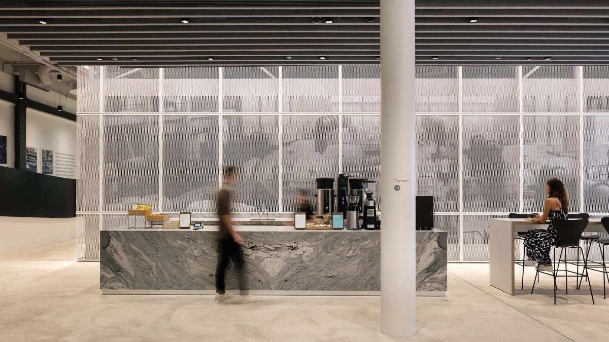 Dyson: Marble coffee counter with espresso machines in a bright white space